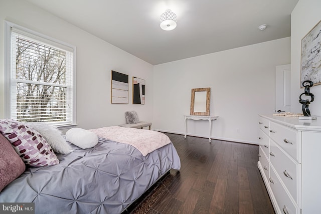 bedroom featuring dark wood finished floors