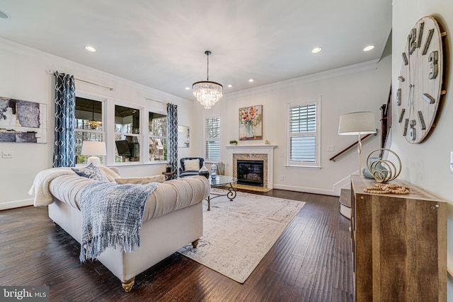 living room featuring ornamental molding, a chandelier, baseboards, recessed lighting, and dark wood-style flooring