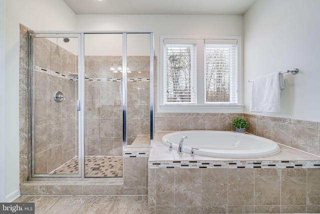 full bath with a stall shower and a bath