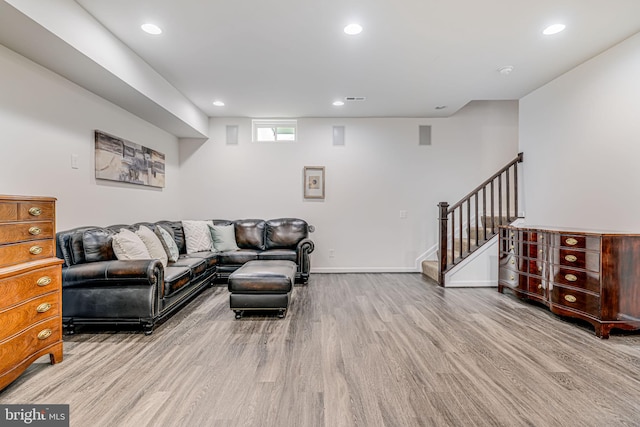 living area featuring wood finished floors, stairs, recessed lighting, and baseboards