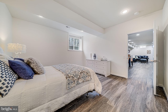 bedroom with wood finished floors, recessed lighting, and baseboards