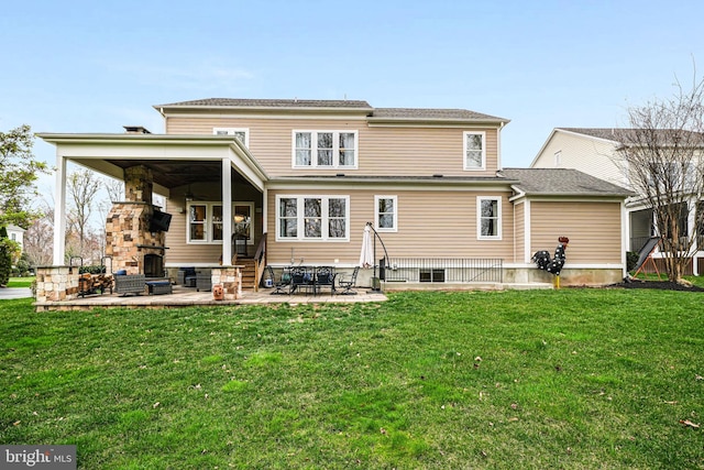 rear view of property featuring a patio, a lawn, and entry steps