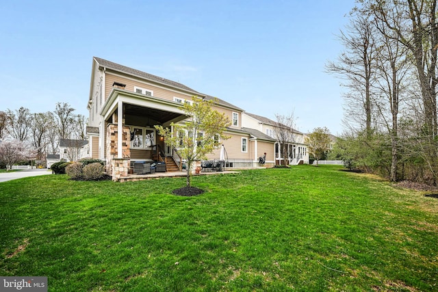back of house with a yard and stone siding