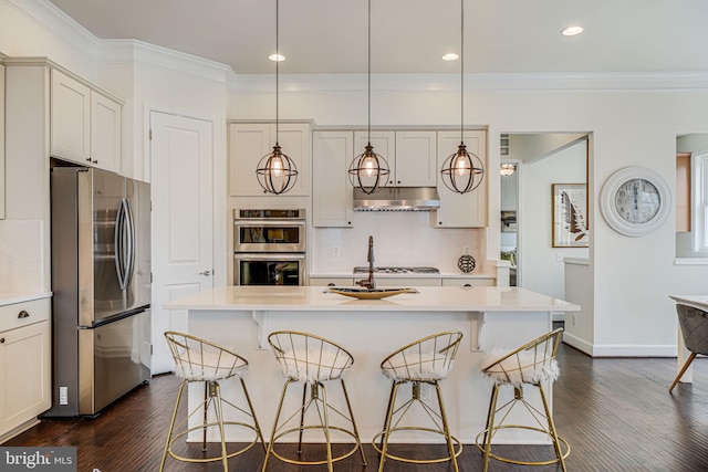 kitchen with stainless steel appliances, a kitchen breakfast bar, light countertops, crown molding, and recessed lighting