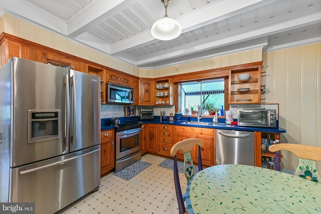 kitchen with brown cabinetry, open shelves, beam ceiling, light floors, and stainless steel appliances