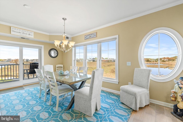 dining room featuring crown molding, baseboards, a notable chandelier, and visible vents