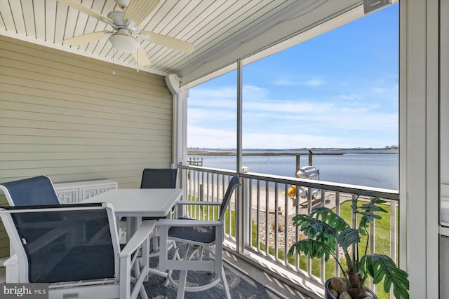 balcony with a water view and ceiling fan