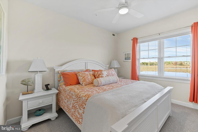 bedroom with baseboards, a ceiling fan, and light carpet