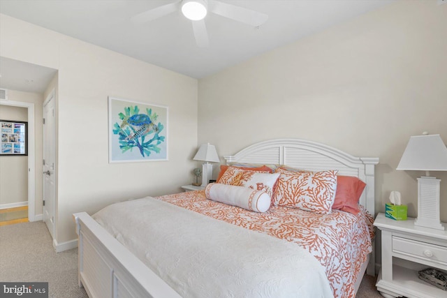 bedroom with baseboards, carpet, a ceiling fan, and visible vents