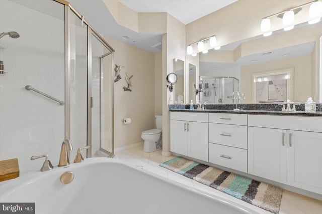 full bathroom featuring double vanity, a stall shower, tile patterned floors, and toilet