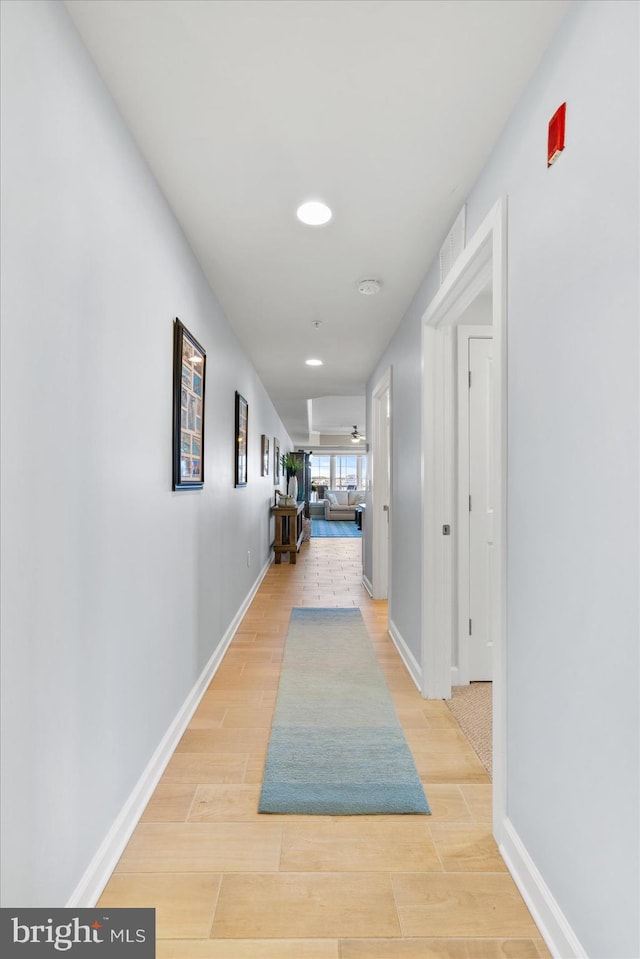 corridor with recessed lighting, baseboards, and light wood-style flooring