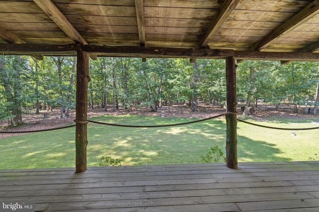 wooden terrace with a lawn
