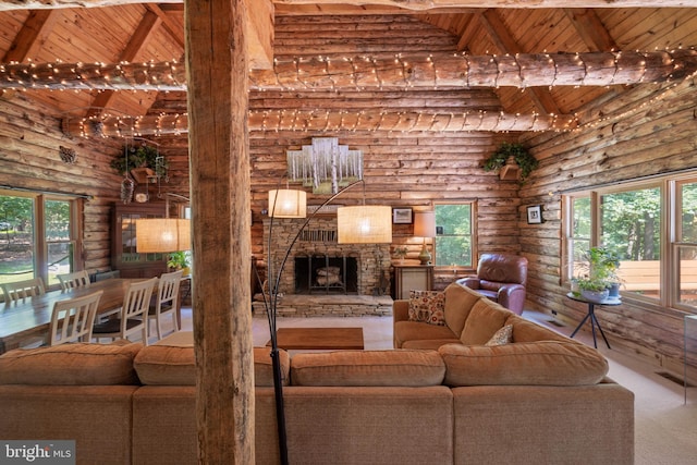 carpeted living area with high vaulted ceiling, wooden ceiling, and log walls