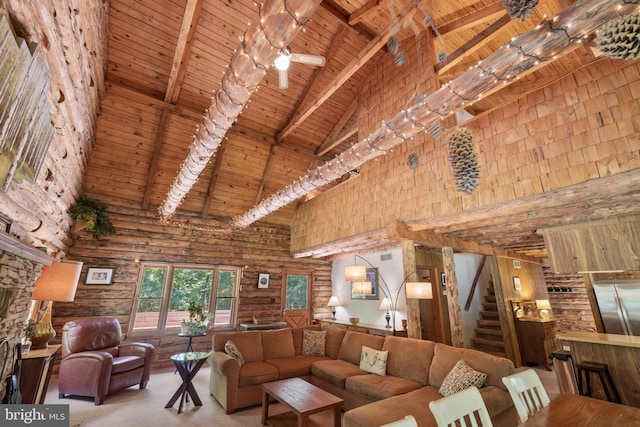 living room with wood ceiling, stairway, high vaulted ceiling, beamed ceiling, and rustic walls