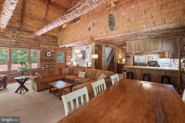 dining area with beam ceiling, stairway, high vaulted ceiling, wooden ceiling, and log walls