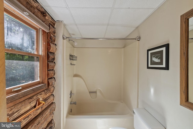 full bathroom with a paneled ceiling, toilet, a healthy amount of sunlight, and shower / bathing tub combination