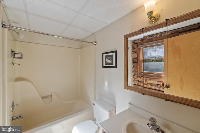bathroom featuring vanity,  shower combination, a paneled ceiling, and toilet