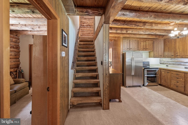 stairway featuring beamed ceiling, wood ceiling, and rustic walls