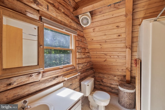 bathroom featuring vanity, rustic walls, toilet, and visible vents