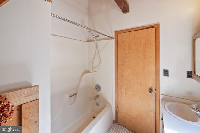 bathroom with shower / washtub combination and a sink