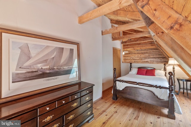 bedroom with light wood-type flooring, lofted ceiling with beams, and wood ceiling