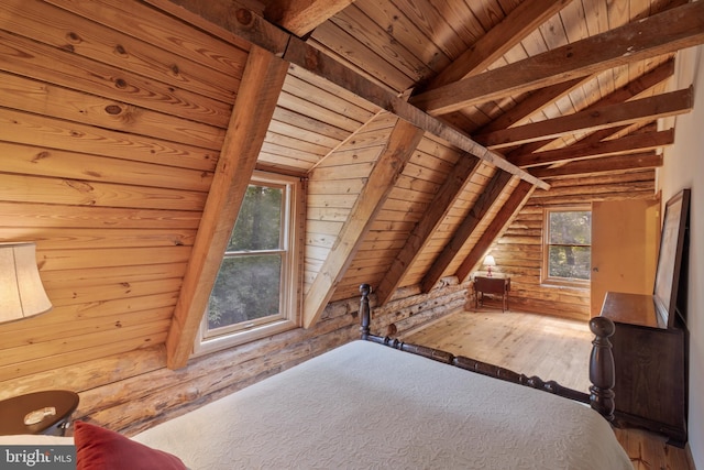 unfurnished bedroom with wooden walls, wood ceiling, vaulted ceiling with beams, and hardwood / wood-style flooring