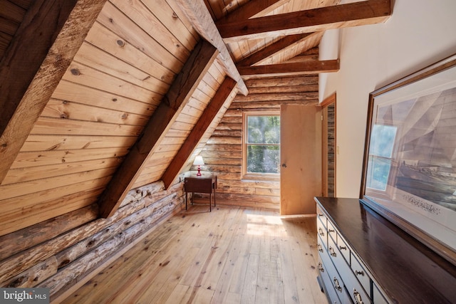 additional living space with lofted ceiling with beams, wooden ceiling, and light wood-style flooring