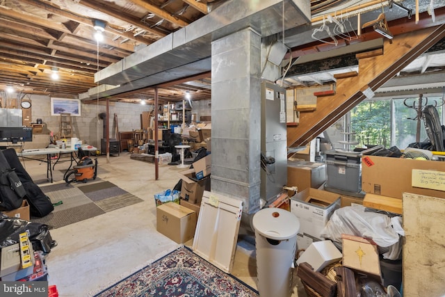 below grade area featuring stairway and concrete block wall
