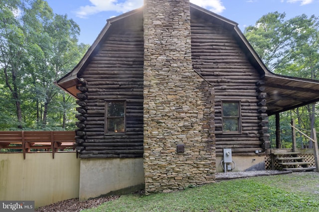 view of property exterior featuring log siding and a chimney
