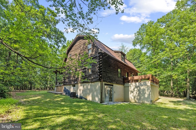view of side of property featuring a yard and log exterior