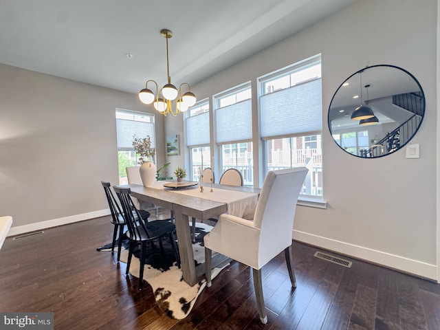 dining room featuring a healthy amount of sunlight, baseboards, an inviting chandelier, and visible vents