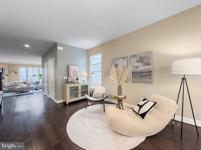 living area with recessed lighting, baseboards, and wood finished floors