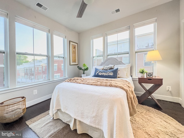 bedroom with baseboards, a ceiling fan, and visible vents