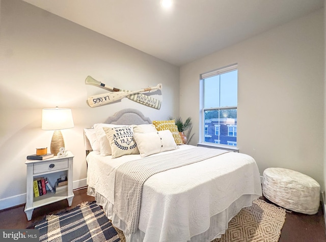bedroom with baseboards and lofted ceiling