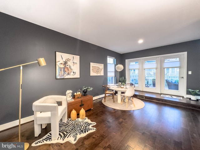 office space with baseboards and wood finished floors