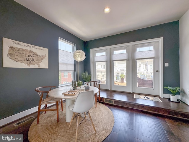 dining room featuring wood-type flooring, recessed lighting, baseboards, and visible vents
