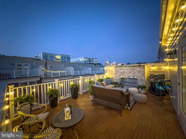 patio at twilight featuring a grill
