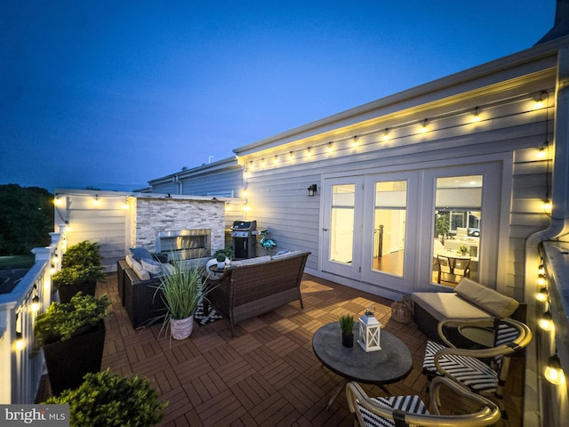 patio at twilight featuring french doors, an outdoor hangout area, and a grill