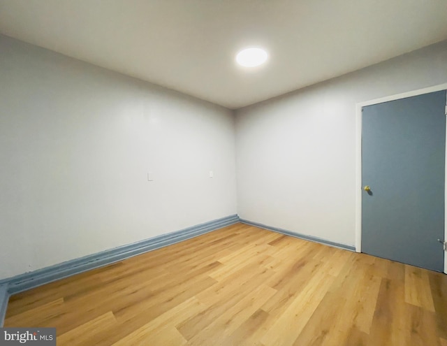 unfurnished room featuring baseboards and wood finished floors