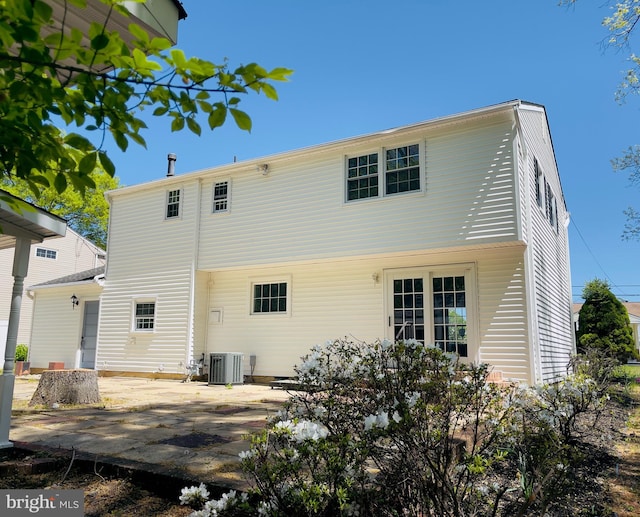 rear view of property with central air condition unit and a patio area
