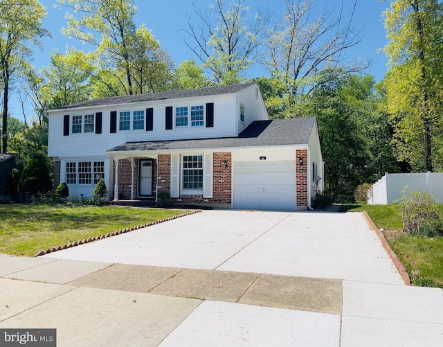 traditional home featuring driveway, a front yard, brick siding, fence, and an attached garage