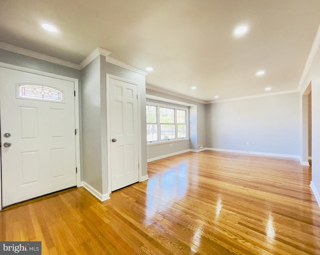 entryway with recessed lighting, baseboards, ornamental molding, and light wood-type flooring