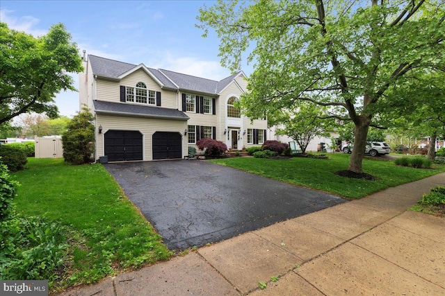 view of front of home featuring asphalt driveway and a garage