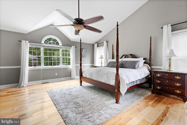 bedroom featuring vaulted ceiling, wood finished floors, a ceiling fan, and baseboards