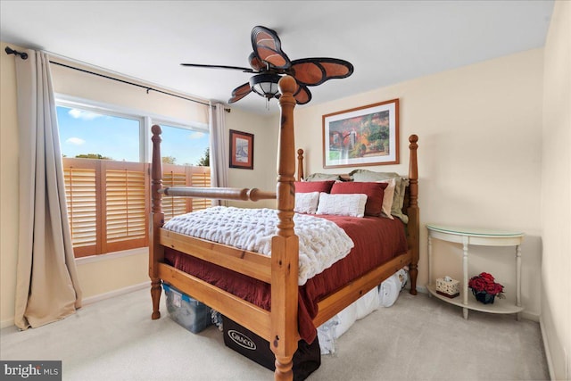 carpeted bedroom featuring baseboards and a ceiling fan