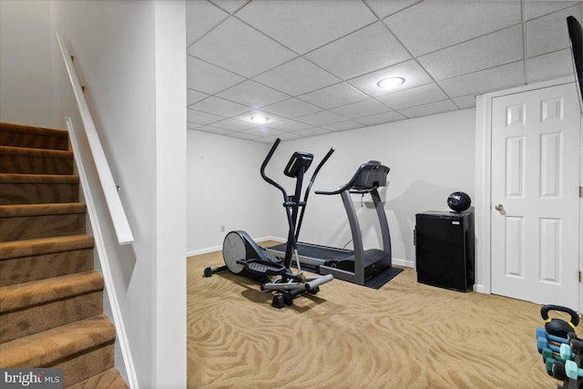 exercise area with carpet flooring, baseboards, a drop ceiling, and recessed lighting