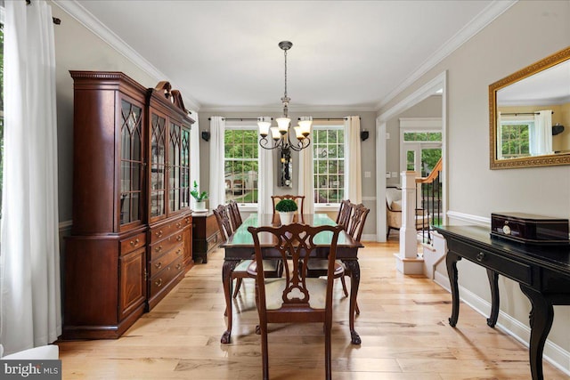 dining area with a chandelier, crown molding, light wood-style flooring, and baseboards