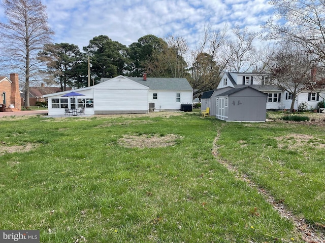 3 Talbot Ave, Cambridge, MD 21613 - view of grassy yard with an outdoor structure, a storage unit, and central AC unit