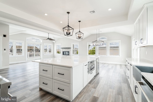 339 11th, Ship Bottom, NJ 08008 - kitchen featuring open floor plan, light wood-type flooring, white cabinetry, recessed lighting, and baseboards