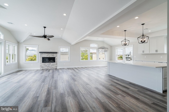 339 11th, Ship Bottom, NJ 08008 - unfurnished living room with wood finished floors, vaulted ceiling, a fireplace, baseboards, and a ceiling fan